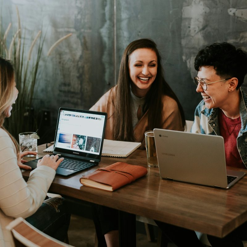 young people discussing work at table